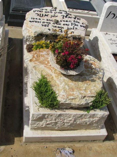 מצבה בחיפה מעוטרת בפרחים מאבן ירושלמית